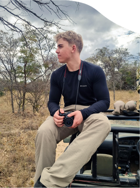 Portrait of Jac holding a camera outdoors